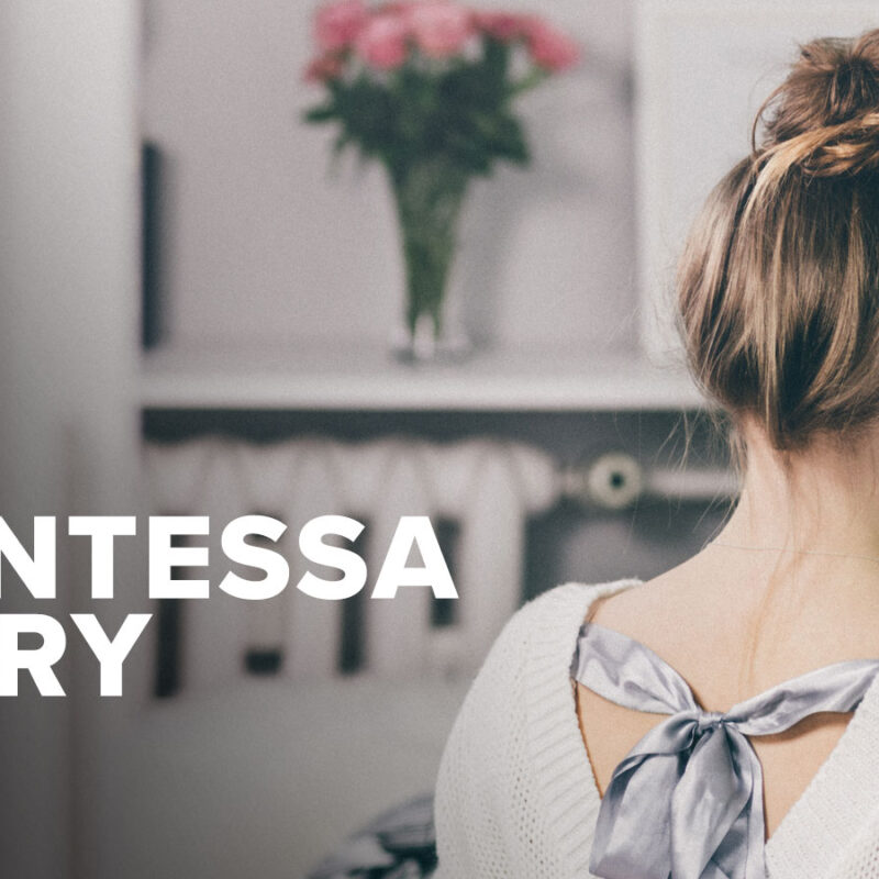Woman facing away towards a wall with flowers on it. The words" My Quintessa Story: Part 1" are written next to her