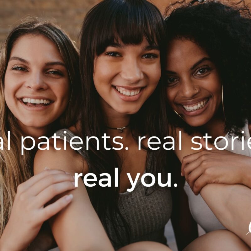 Three young women sitting next to each other smiling