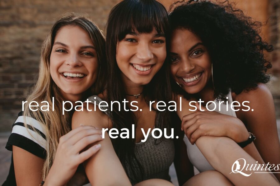 Three young women sitting next to each other smiling
